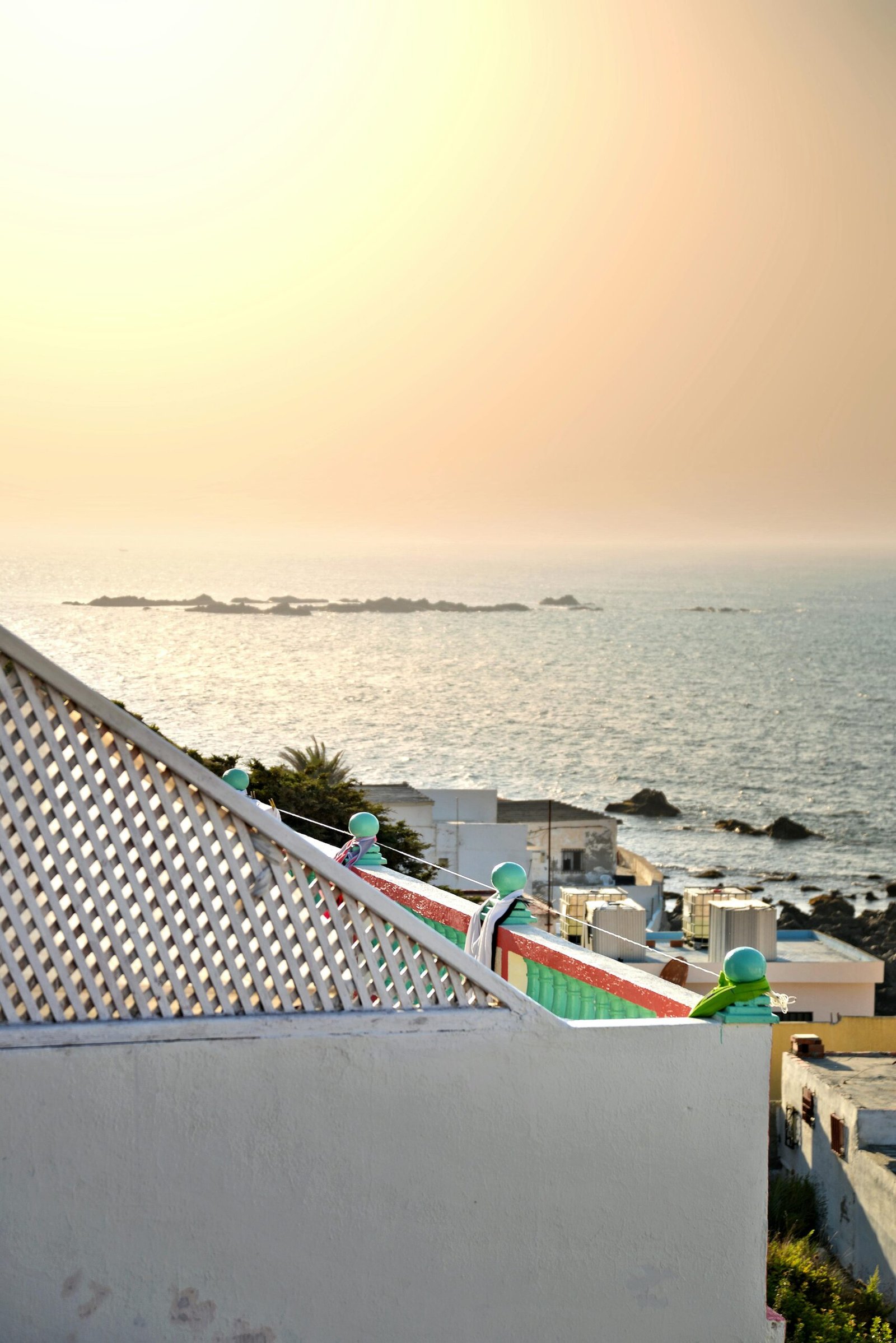 A tranquil sunset view from a rooftop overlooking the sea in Tanger, Morocco.