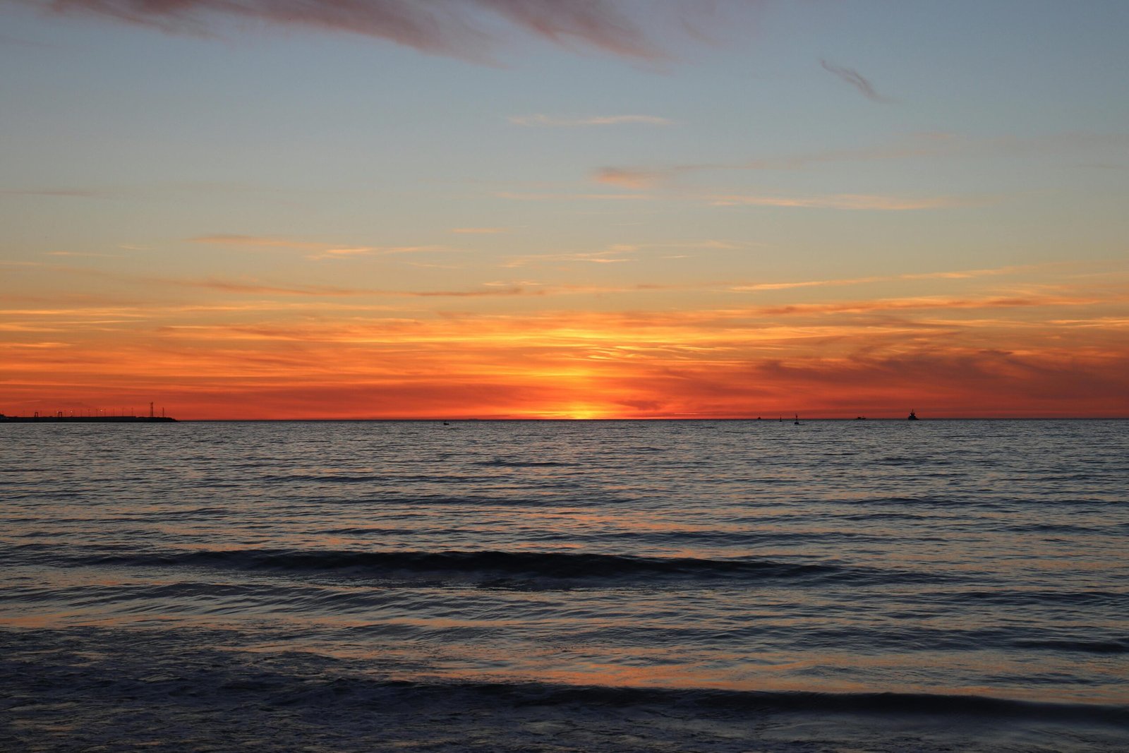 Capture the breathtaking sunset over Tanger's ocean horizon with vibrant colors.
