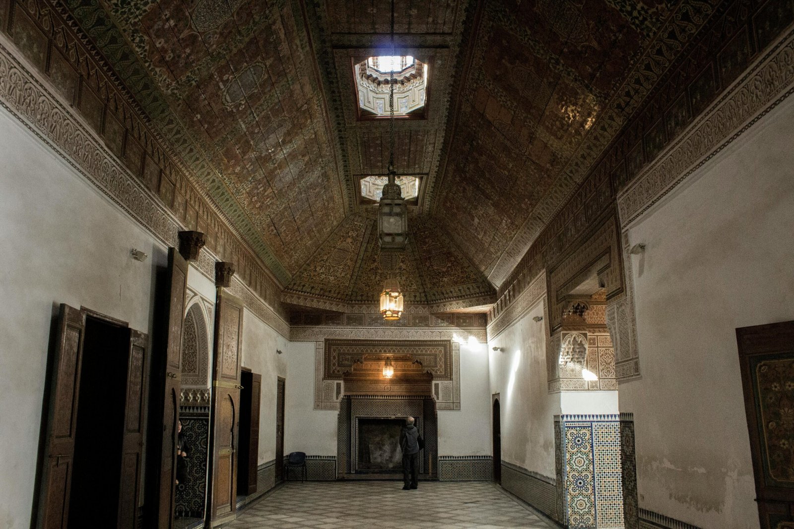 Explore a beautifully ornate interior room featuring traditional Moroccan ceilings and architecture.